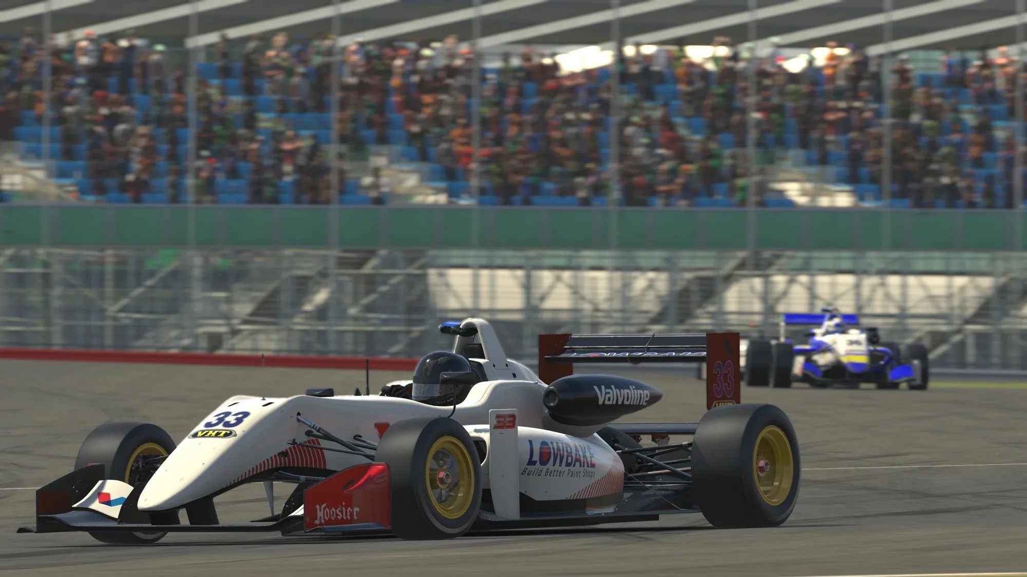 Sim racing screenshot of a white #33 open-wheel car in front of a packed grandstand