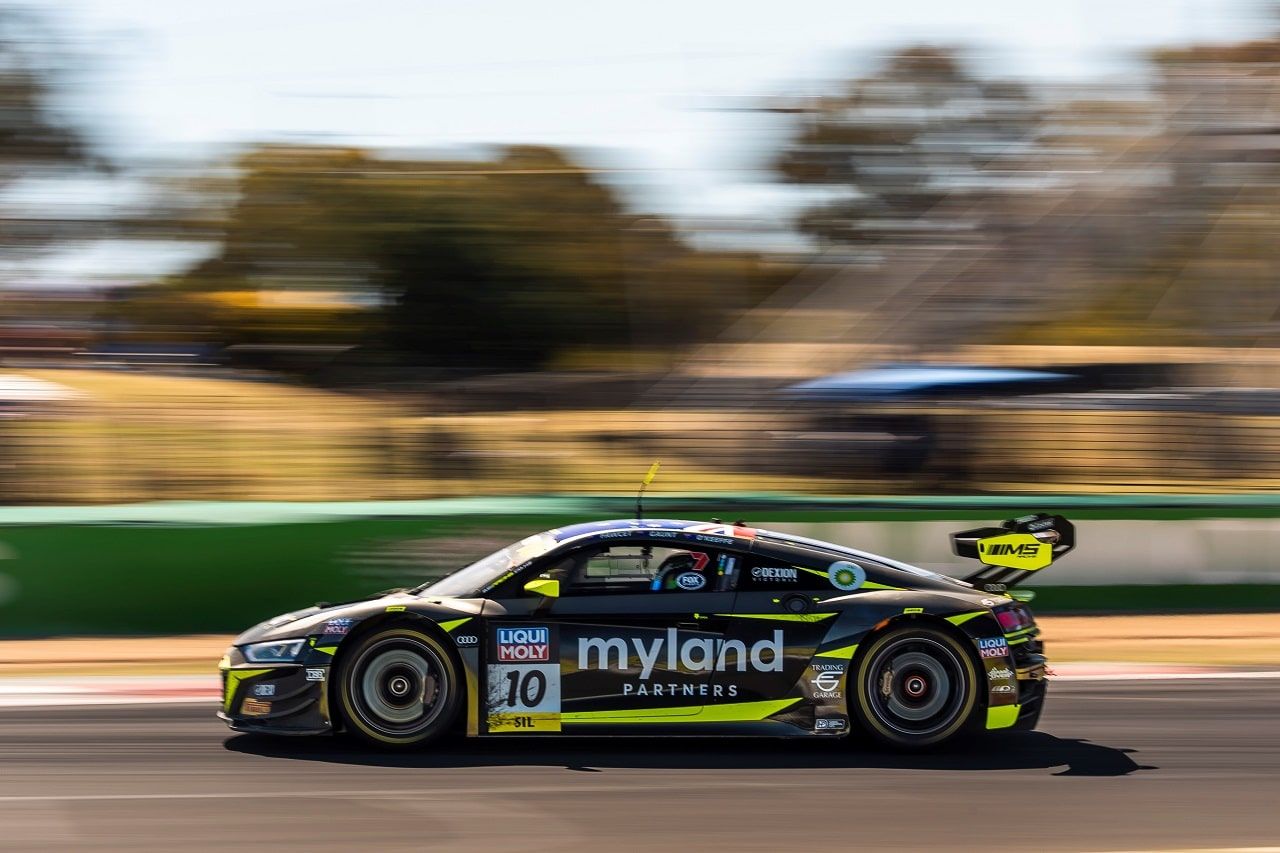 The black and yellow Myland Partners Audi R8 GT3, number 10, blurred with speed at Bathurst
