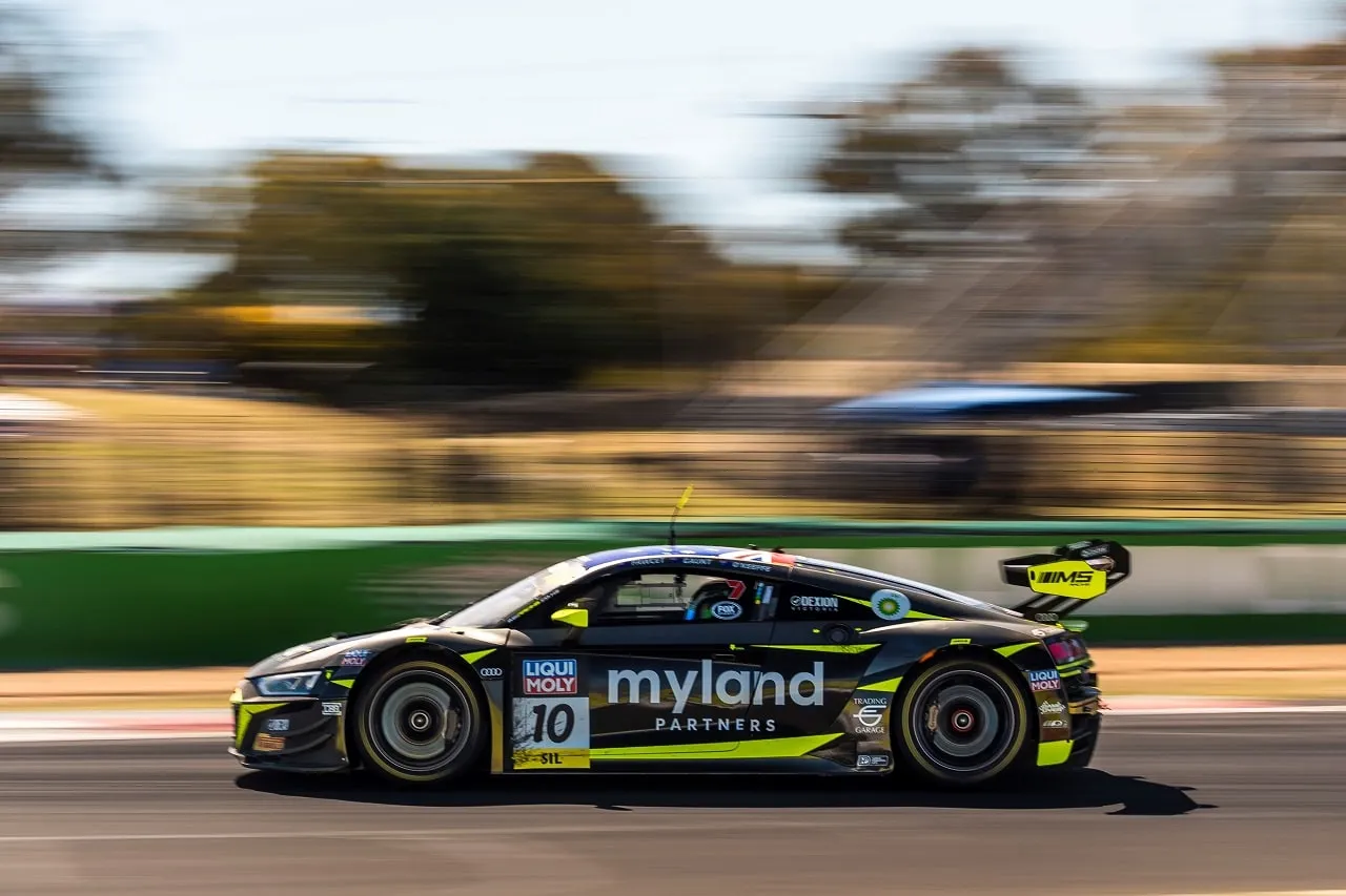 The black and yellow Myland Partners Audi R8 GT3, number 10, blurred with speed at Bathurst