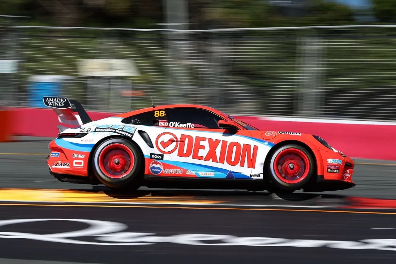 Side view of the Dexion number 88 Porsche 911 GT3 Cup car at speed on a street circuit