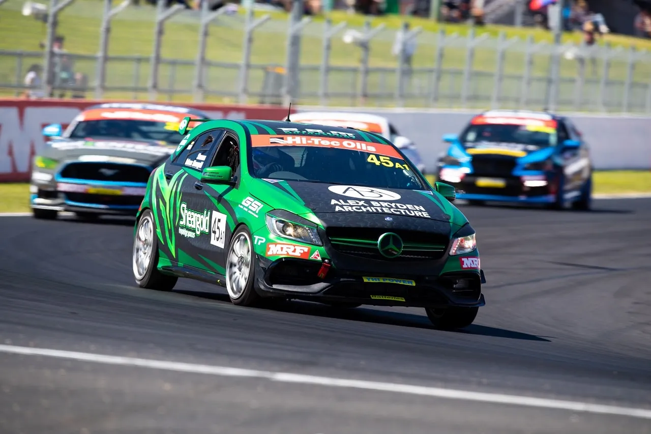 The green #45 Sheargold Mercedes A45 AMG racing on track with other cars close behind