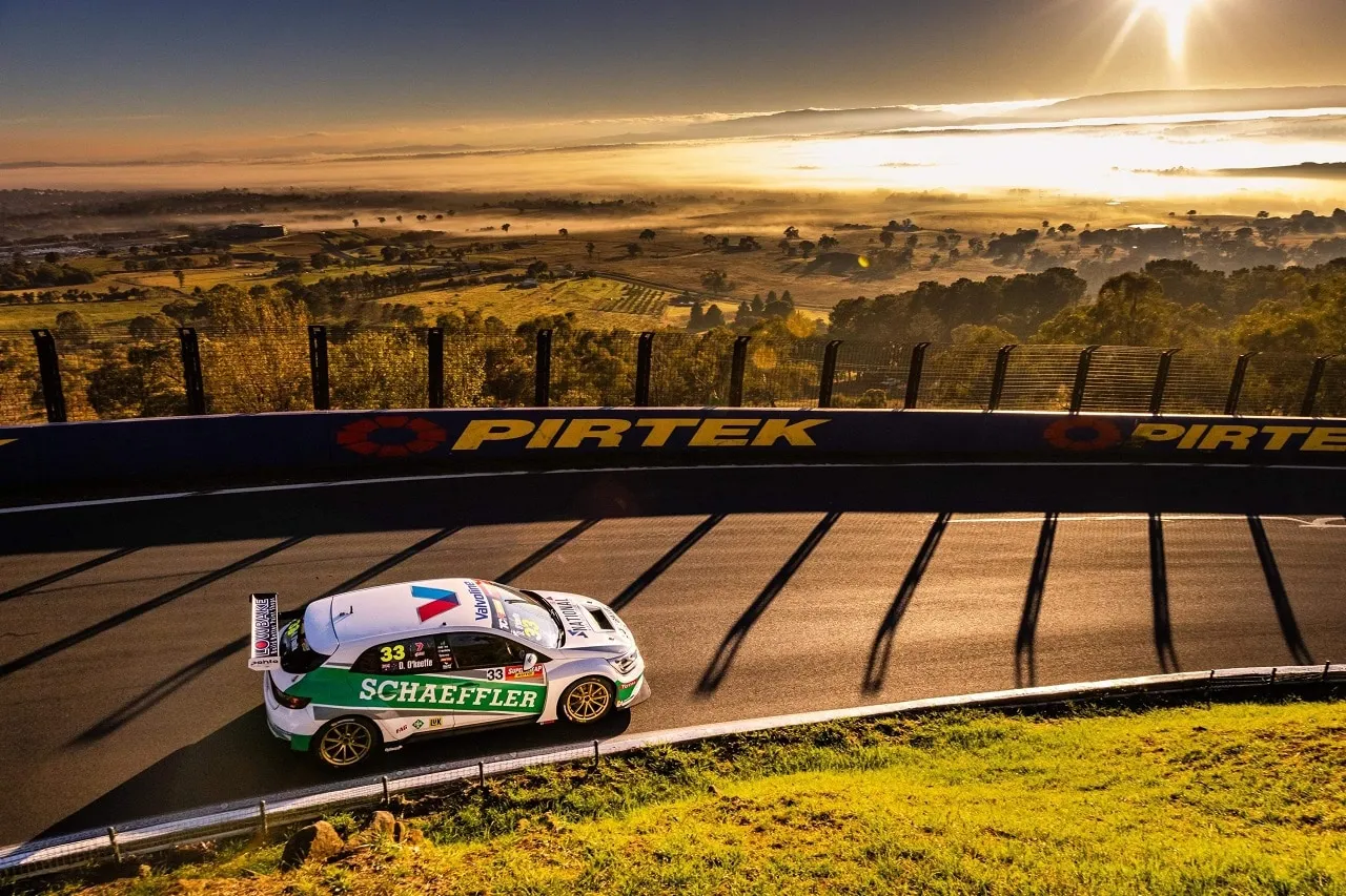 The Schaeffler Renault Megane TCR car #33 on track at sunrise with long shadows across the road at Mount Panorama