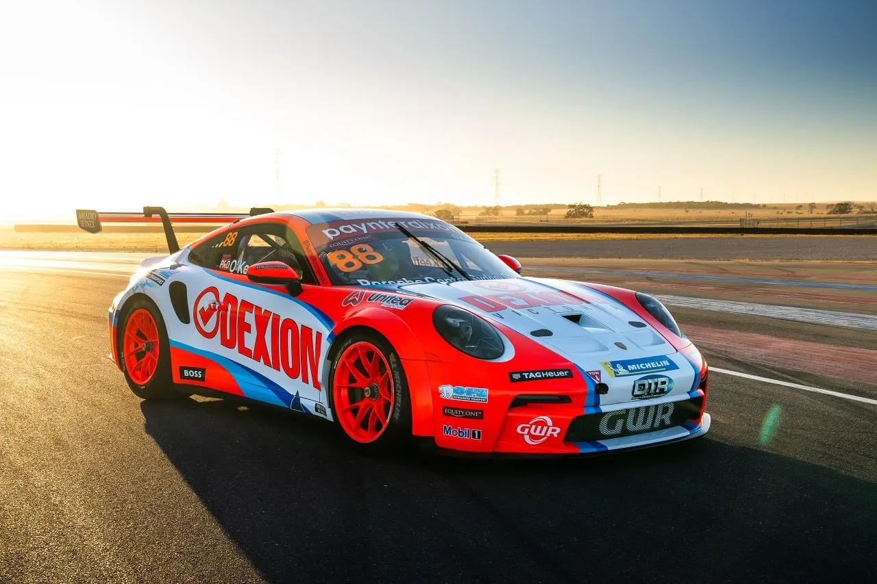 The new red, white and blue Dexion Racing Porsche 911 GT3 Cup car, number 88, parked on track at sunset