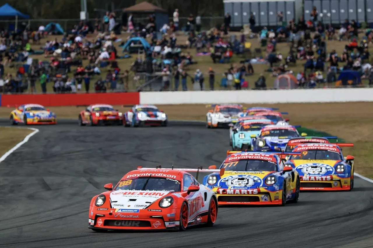 Dexion Porsche #88 leading a pack of Carrera Cup cars out of a corner
