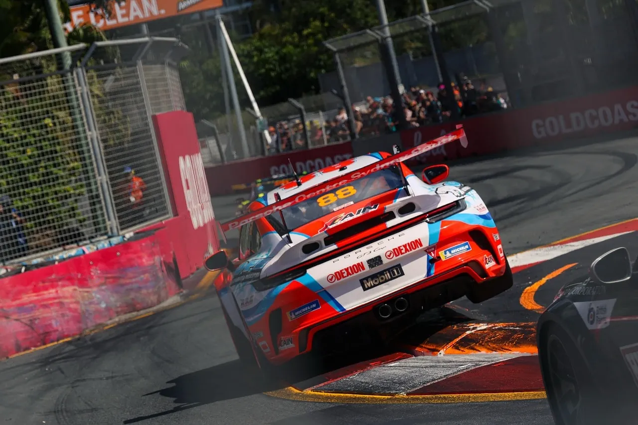 Rear three-quarter view of the number 88 Dexion Porsche Carrera Cup car on a street circuit