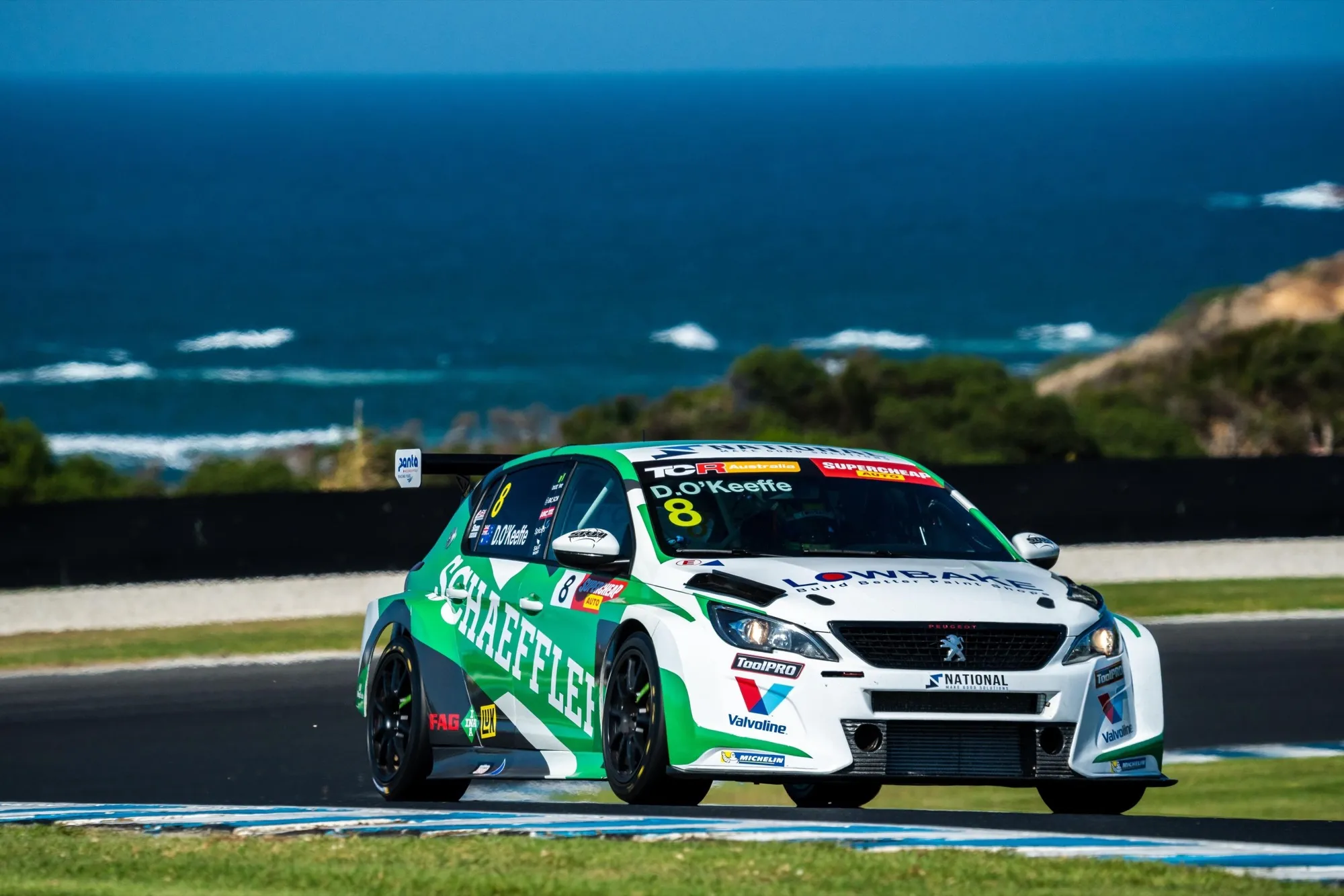 The #8 Schaeffler Peugeot 308 TCR car on track with the ocean behind at Phillip Island