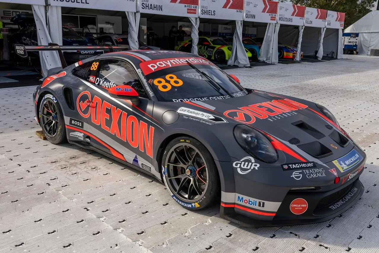 The #88 Dexion Porsche GT3 Cup car in its new grey and orange livery parked on a paddock surface
