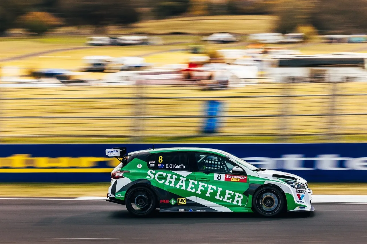 The #8 Schaeffler Peugeot 308 TCR car in side profile, panned for motion blur