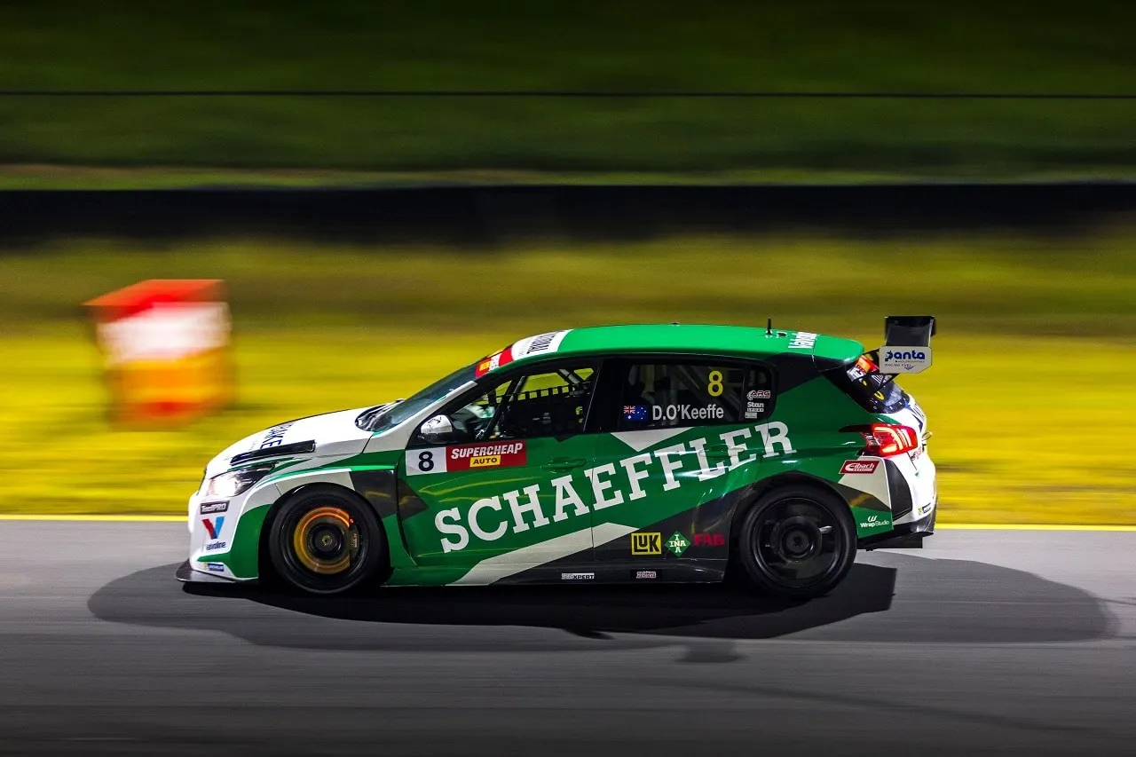 The #8 Schaeffler Peugeot 308 TCR car at speed at night, panned for motion blur