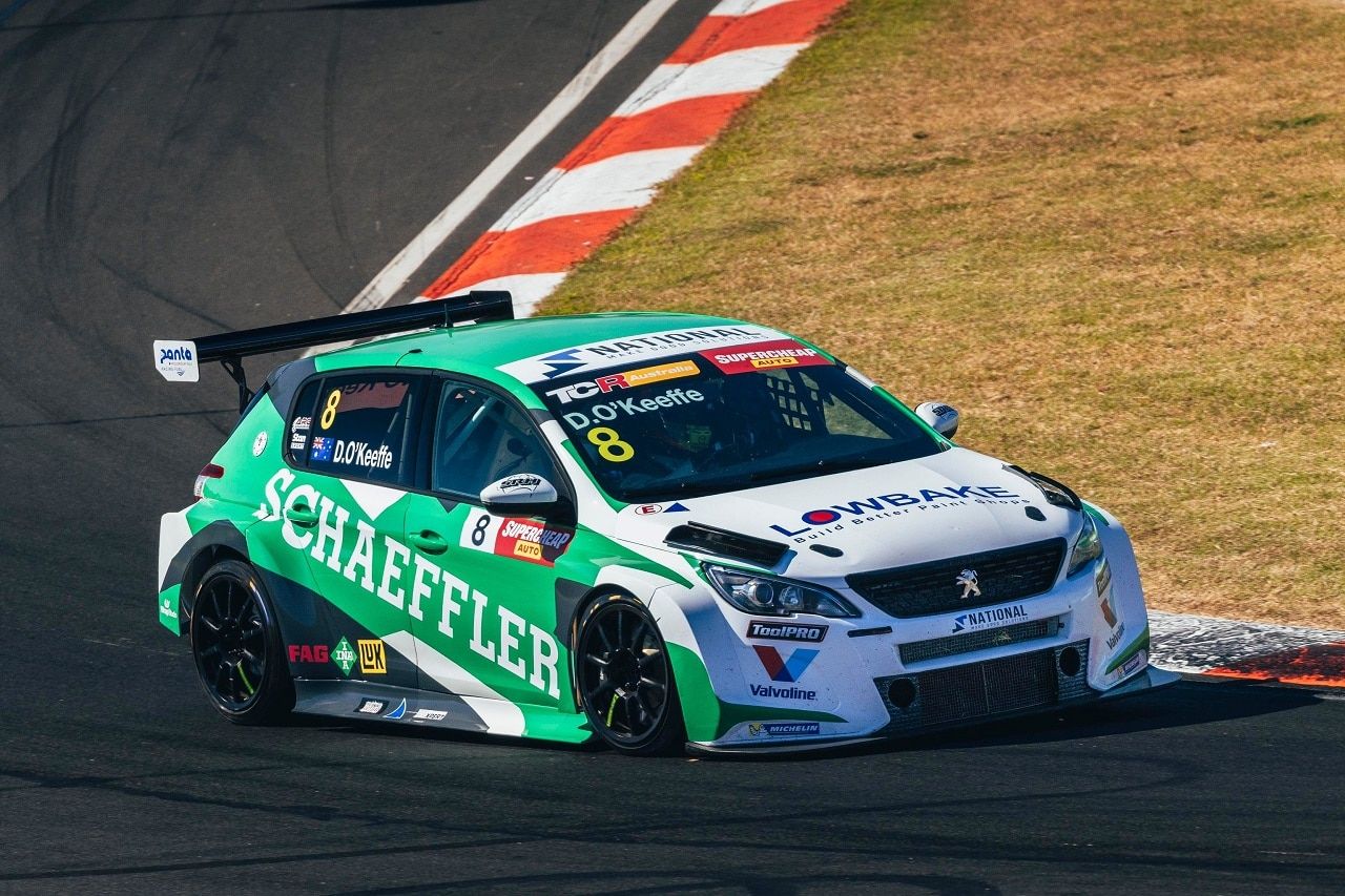 The #8 Schaeffler Peugeot 308 TCR car cornering beside red and white kerbing