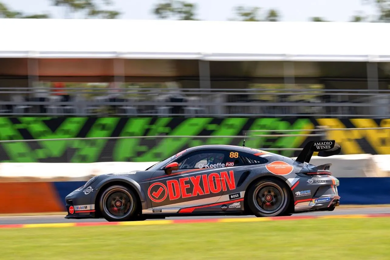The #88 Dexion Porsche GT3 Cup car in side profile in front of grandstands