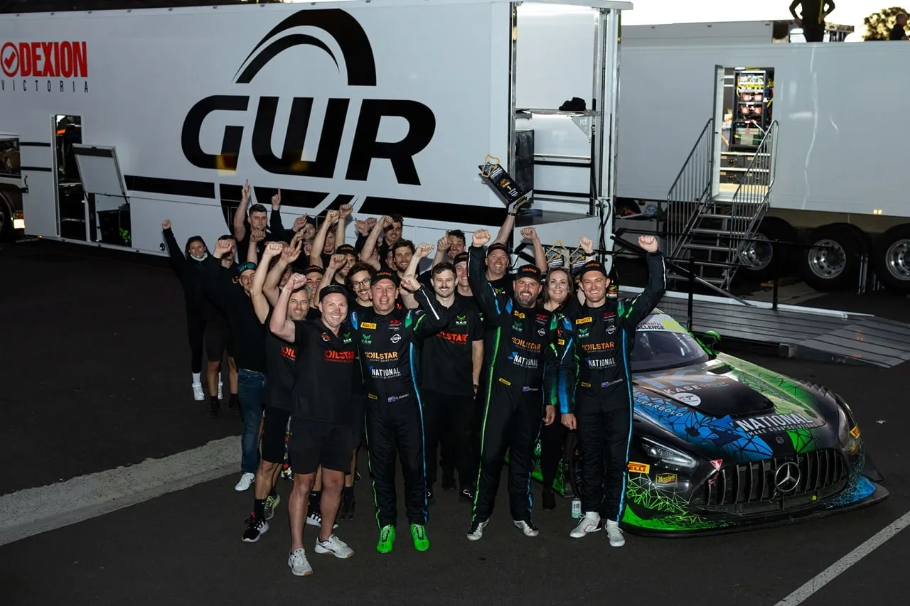 The RAM Motorsport and GWR Australia crew celebrating beside their car and the GWR transporter