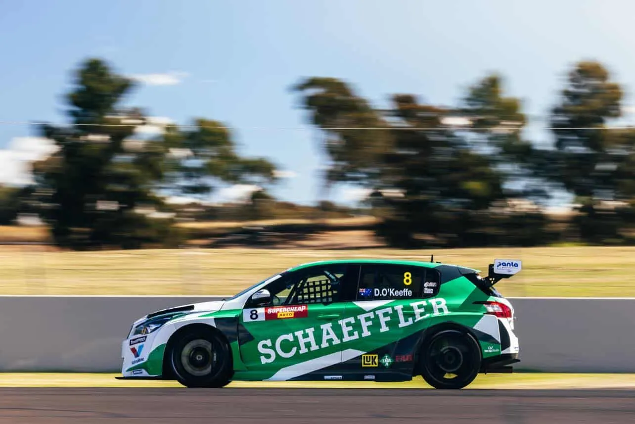Side view of the Schaeffler Peugeot 308 TCR car, number 8, blurred with speed on track
