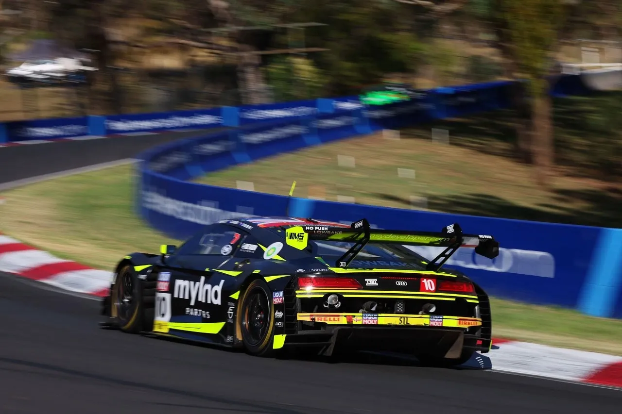 The black and yellow Myland Partners Audi R8 GT3, number 10, at speed on the Mount Panorama circuit at Bathurst