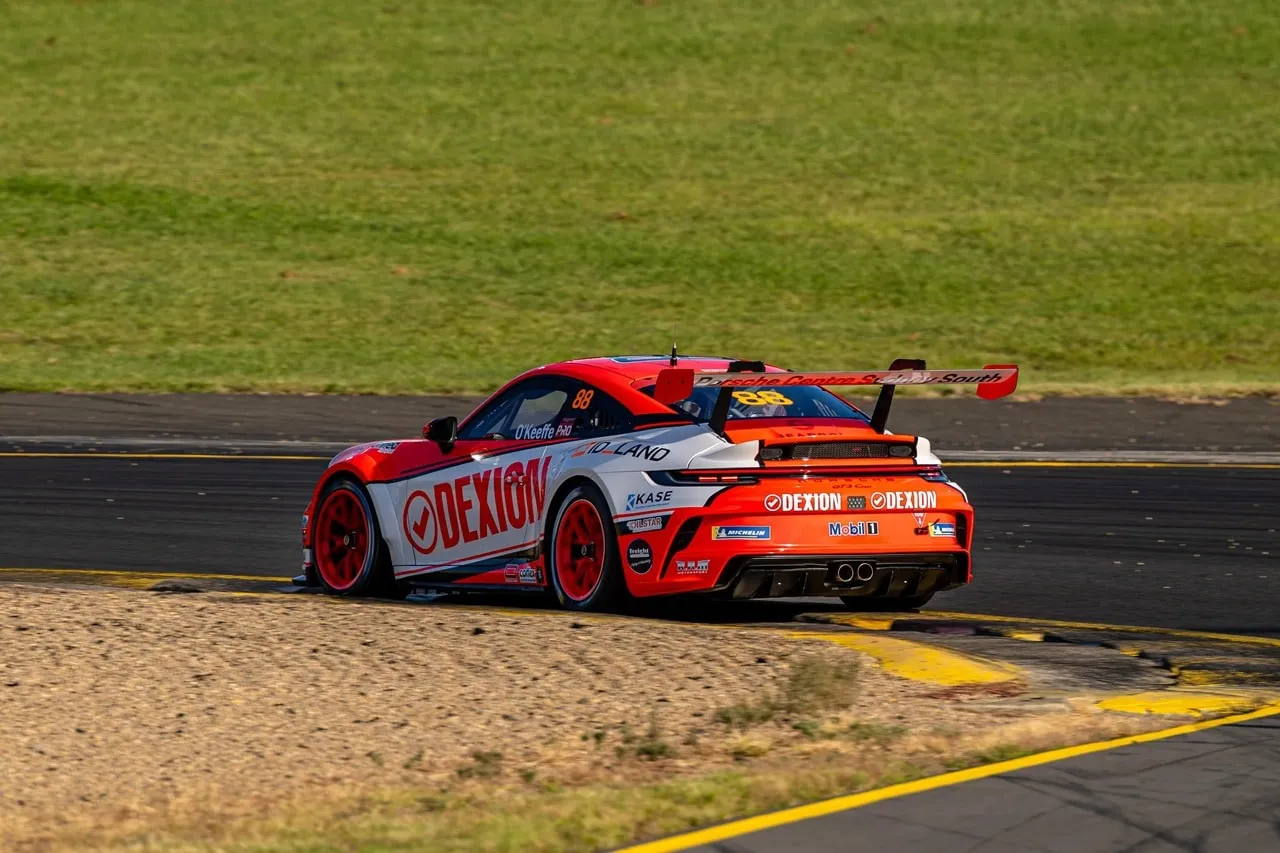 Rear three-quarter view of the Dexion Porsche #88 on track