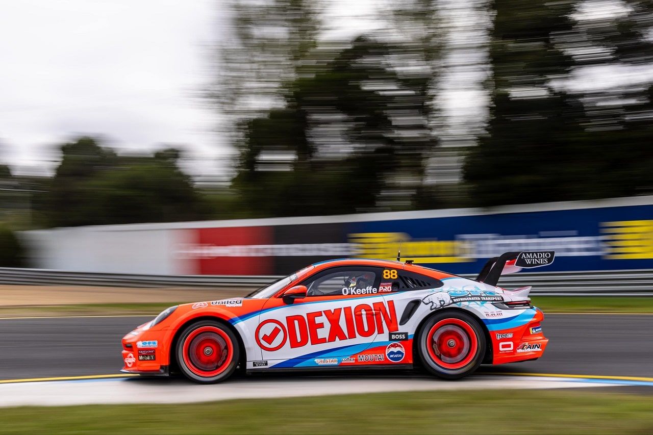 Side view of the number 88 Dexion Porsche 911 GT3 Cup car at speed with a blurred background
