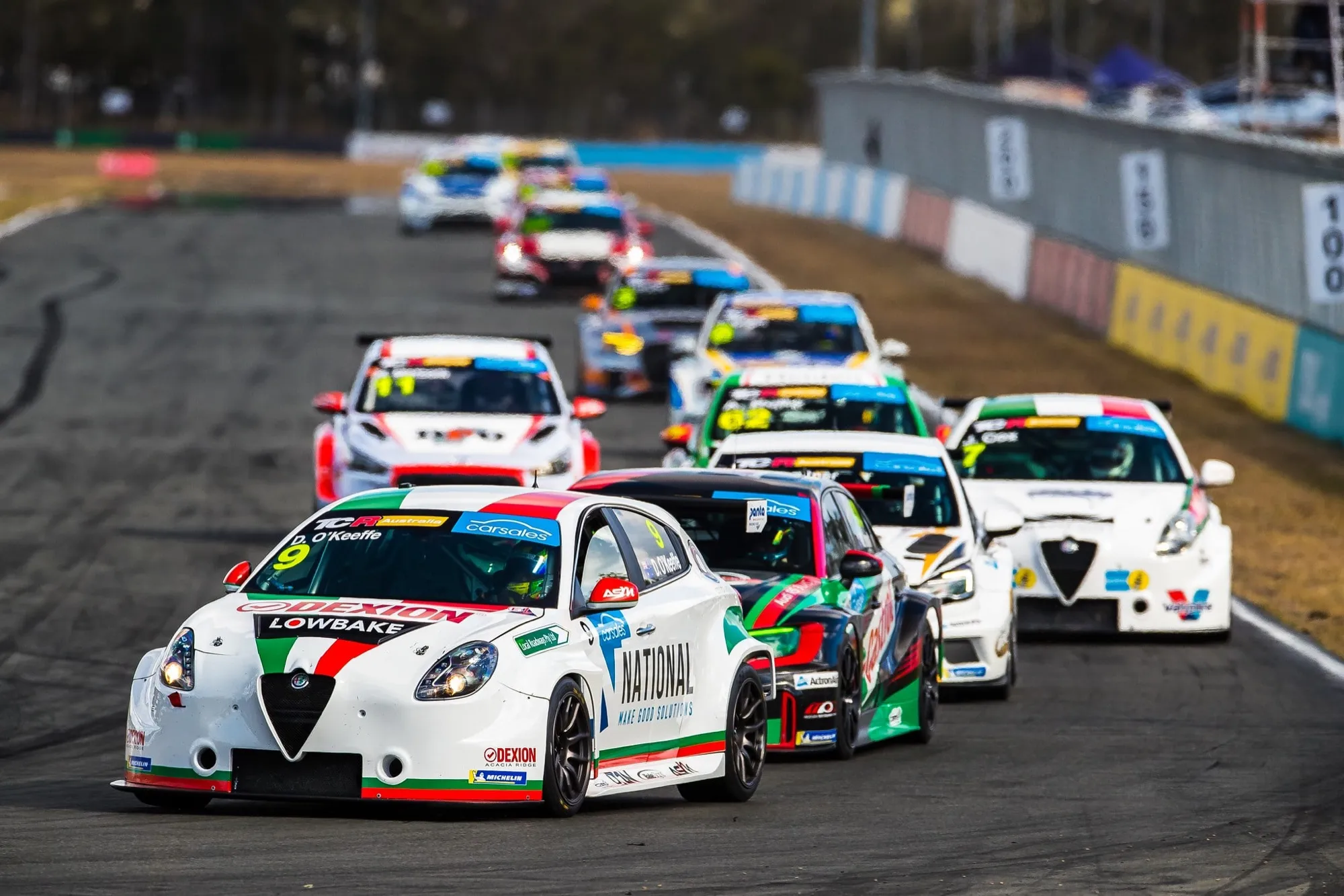 The #9 Dexion Lowbake Alfa Romeo Giulietta TCR car leading a pack of TCR cars along a straight