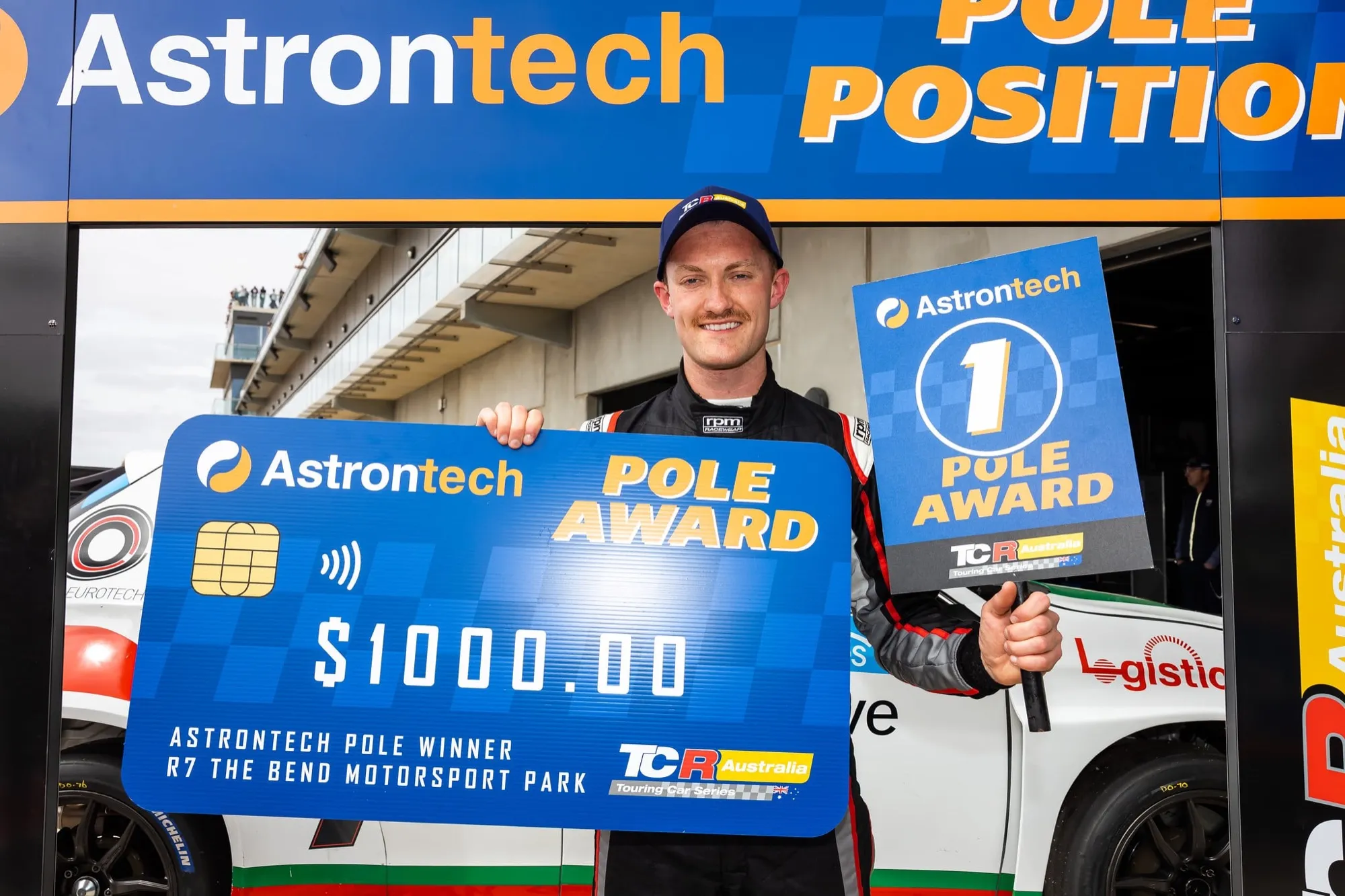 Dylan O’Keeffe holding an oversized $1000 Astrontech Pole Award cheque for the TCR Australia round at The Bend