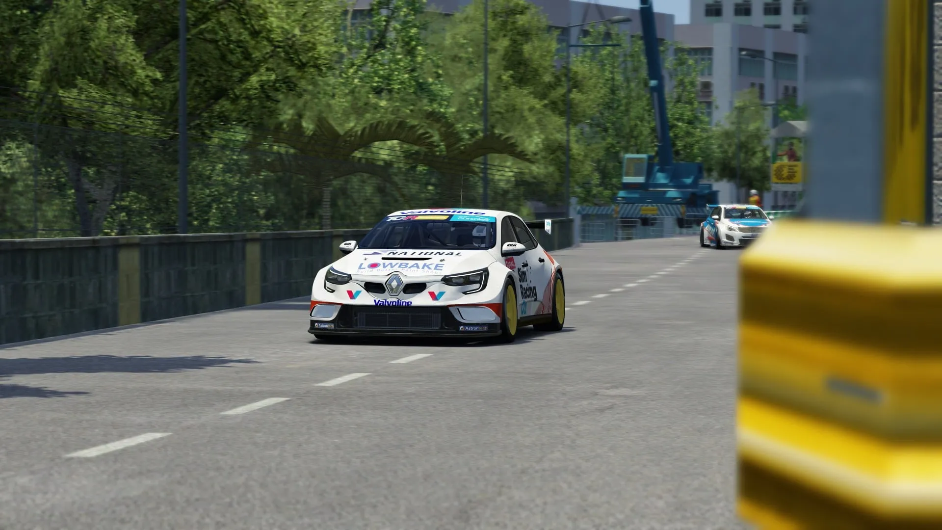 Sim racing screenshot of the white Lowbake Renault Megane TCR car on a city street circuit