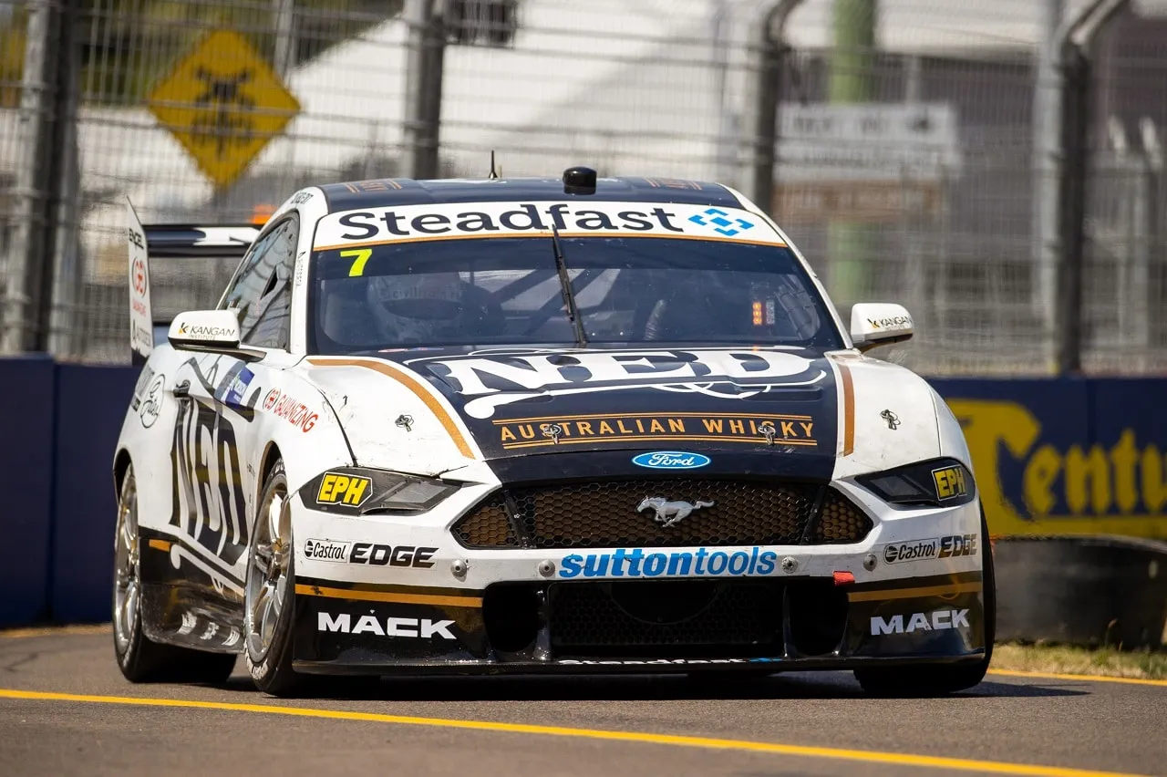 The white #7 NED Whisky Ford Mustang Supercar on track head on at a street circuit