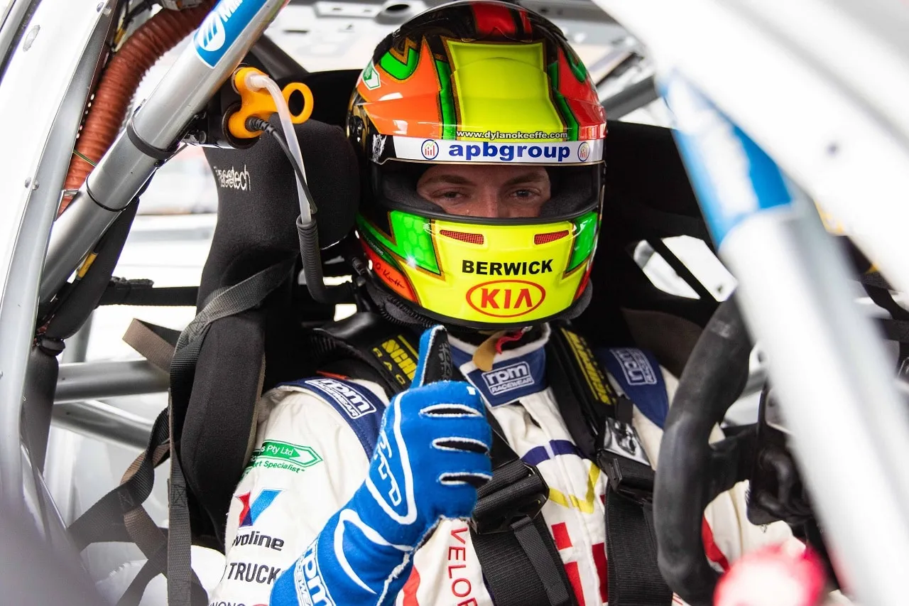 Dylan O’Keeffe giving a thumbs up from the cockpit in an apbgroup helmet showing his website address