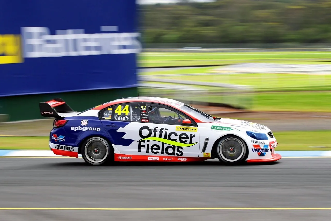 The #44 apbgroup Officer Fields Commodore Supercar captured with motion blur at speed on track