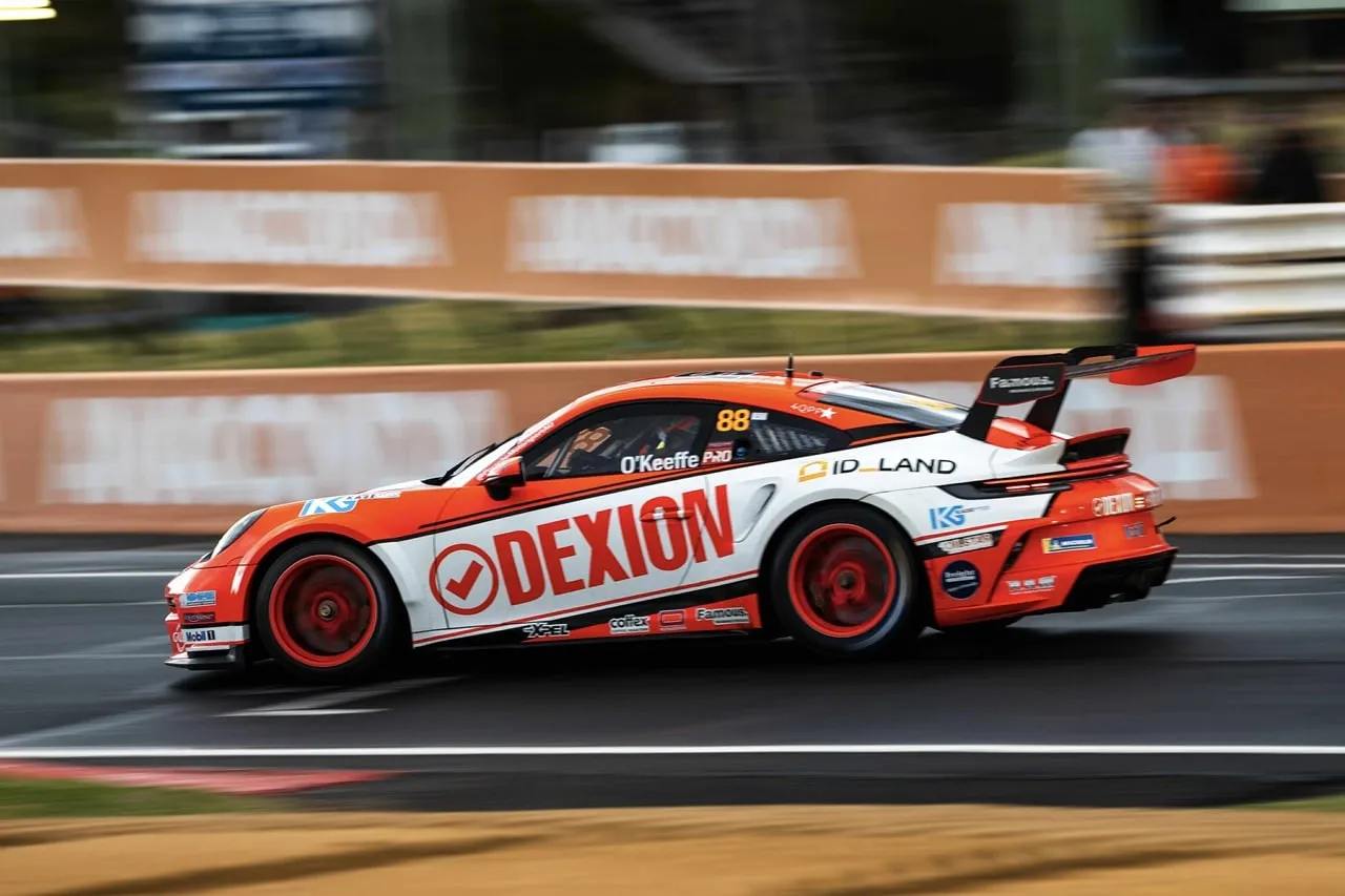 Dexion Porsche #88 speeding past orange wall signage with motion blur