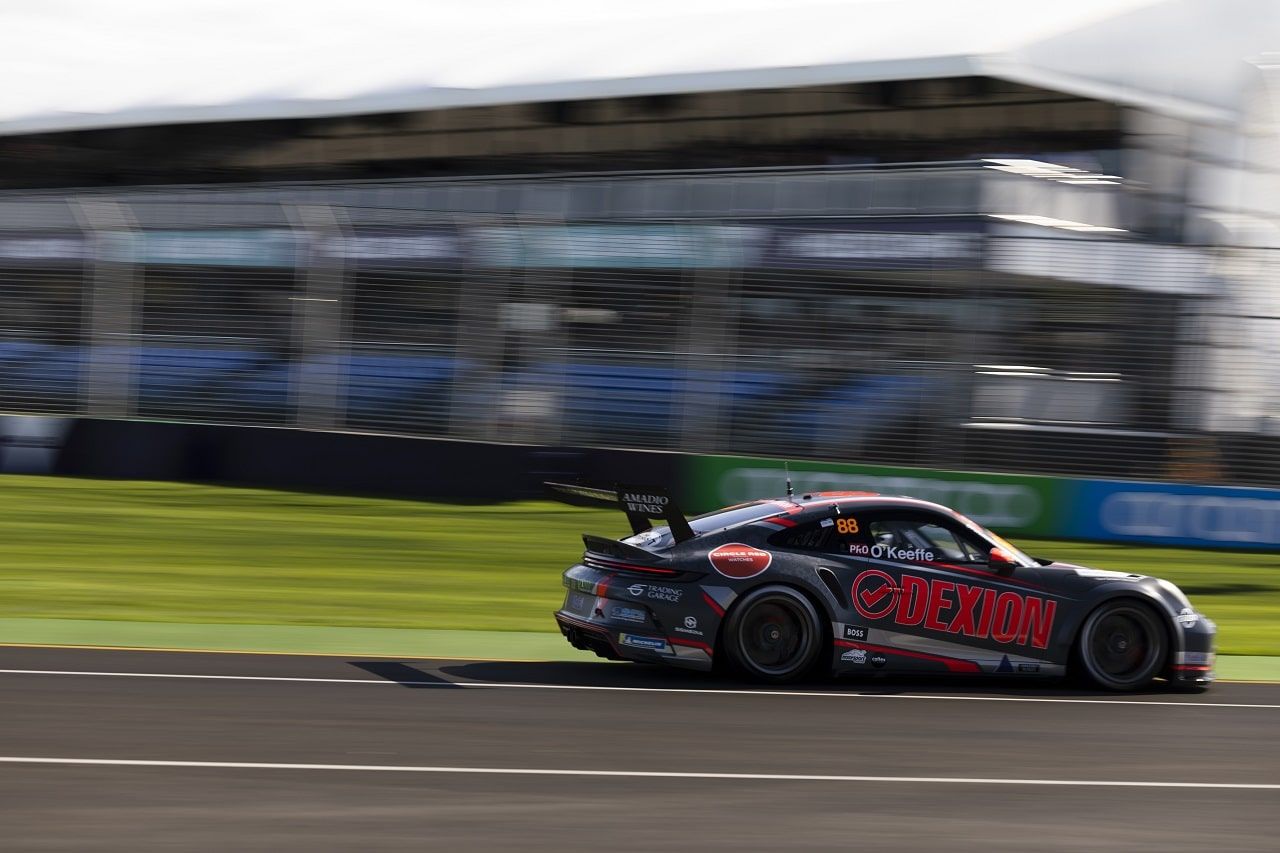 The #88 Dexion Porsche GT3 Cup car in side profile at speed in front of grandstands
