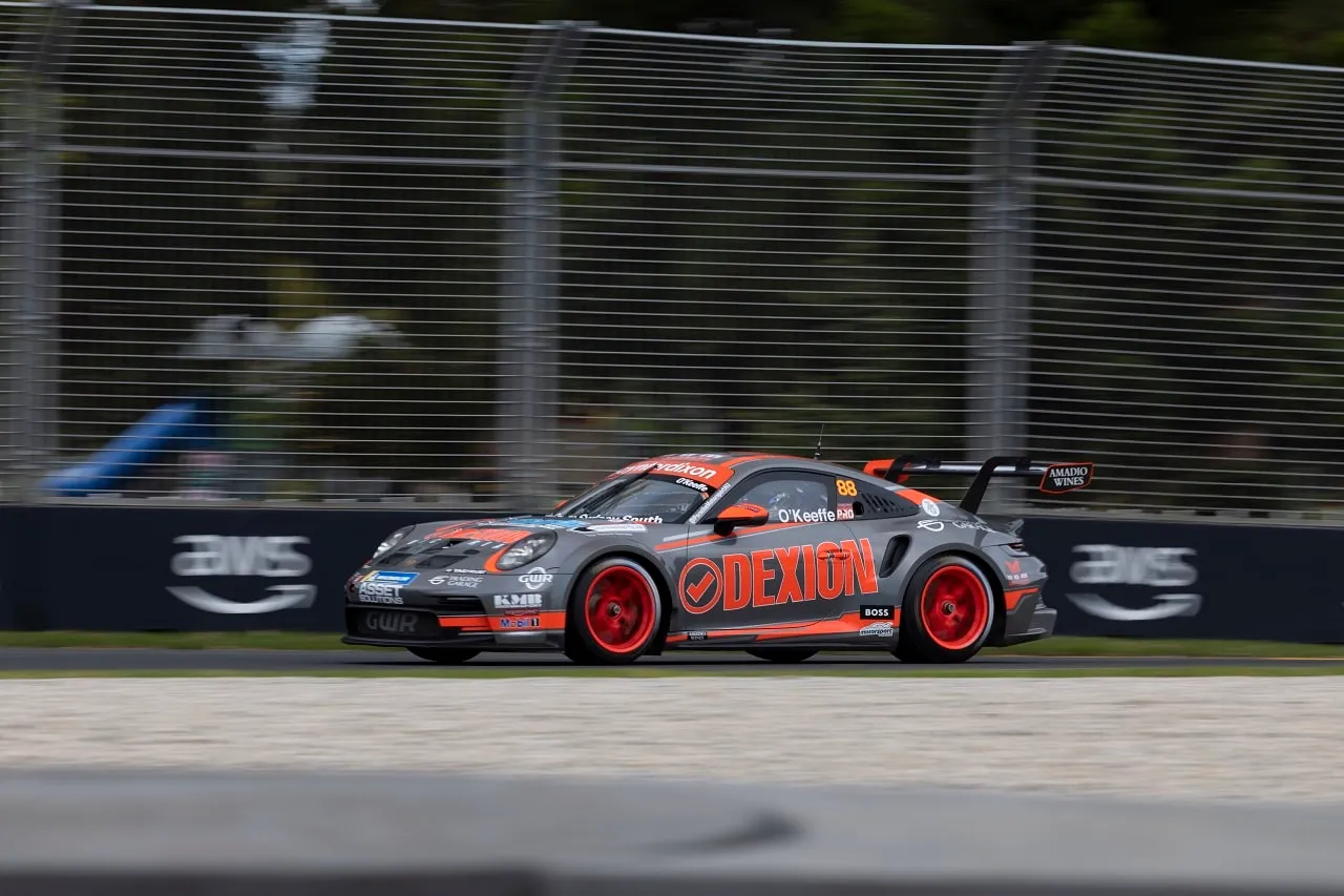 The number 88 Dexion Porsche 911 GT3 Cup car on track at Albert Park in front of AWS signage