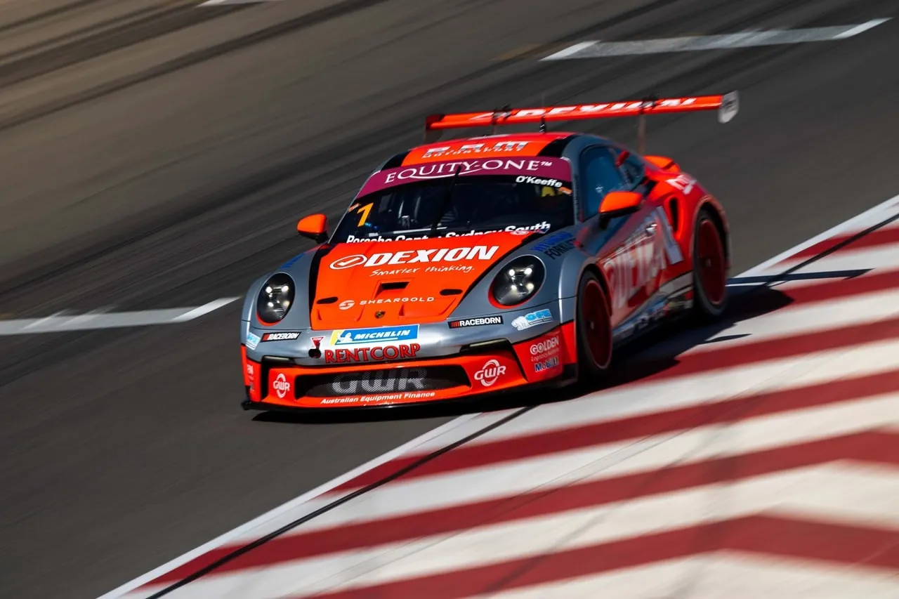 The Dexion Porsche 911 GT3 Cup car riding the red and white kerbs
