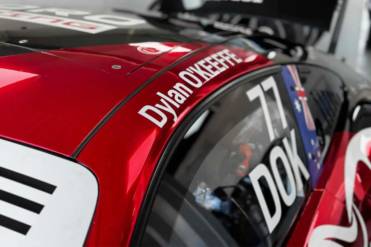 Close-up of the Toro Racing Porsche roof and window reading Dylan O’Keeffe, 77 and DOK