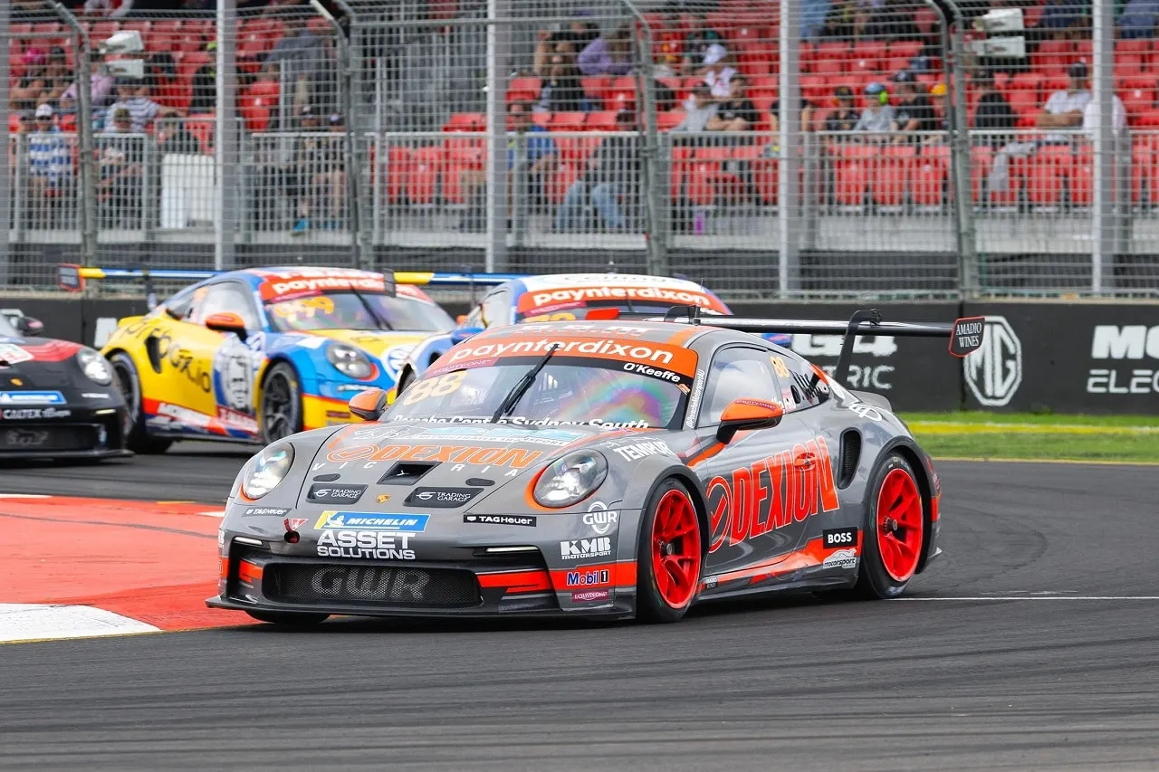 The grey number 88 Dexion Porsche 911 GT3 Cup car racing through the Adelaide street circuit ahead of a yellow rival