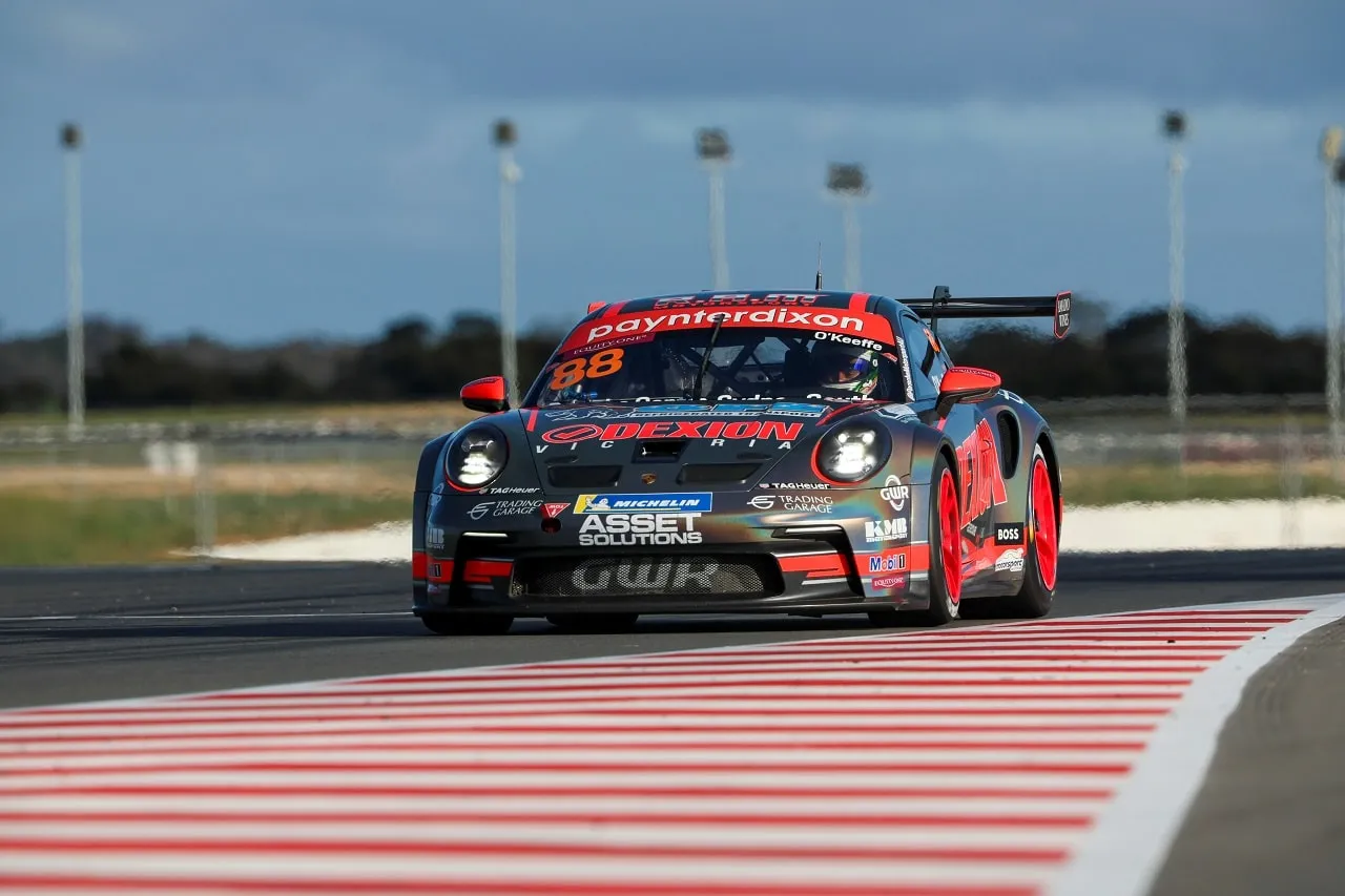 The number 88 Dexion Porsche 911 GT3 Cup car approaching head-on along a red and white kerb at The Bend