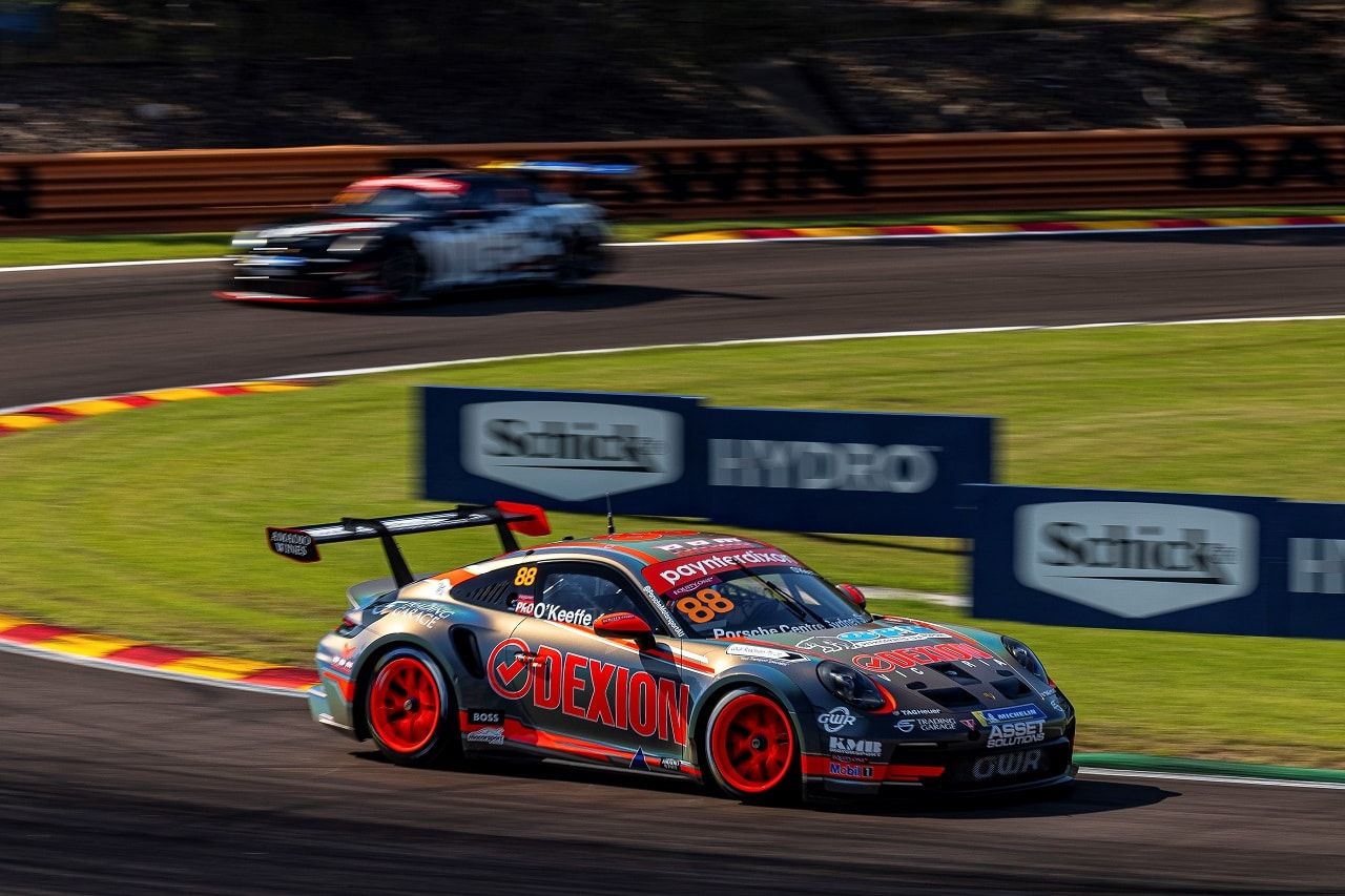 The number 88 Dexion Porsche 911 GT3 Cup car racing at Hidden Valley in Darwin with a black car behind