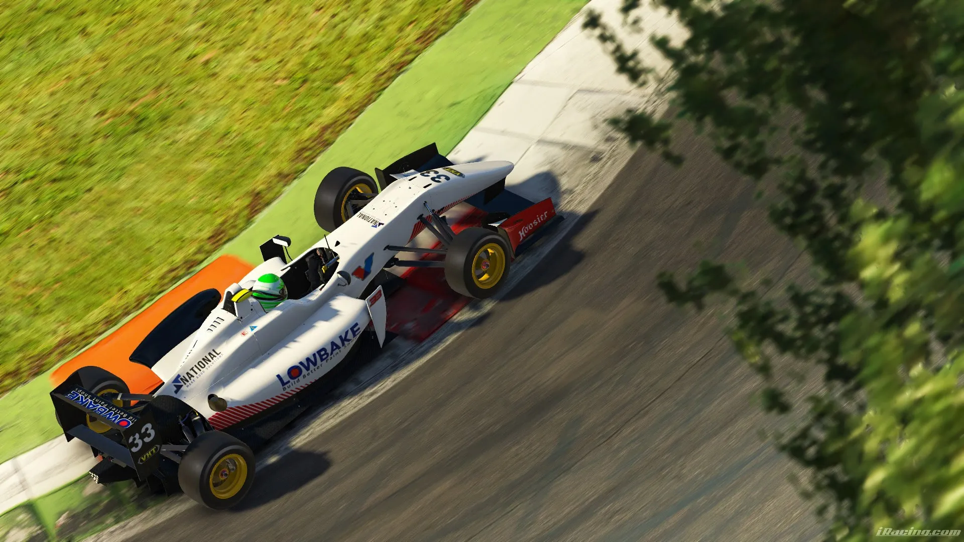 Sim racing screenshot of the white #33 Lowbake open-wheel car cornering on a track with grass and trees