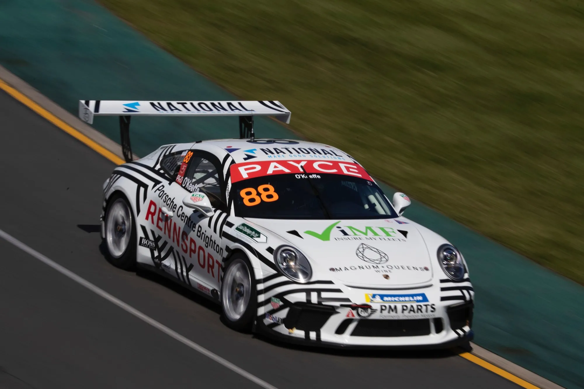 The white and black Porsche 911 GT3 Cup car, #88 PAYCE Carrera Cup, on track at Albert Park