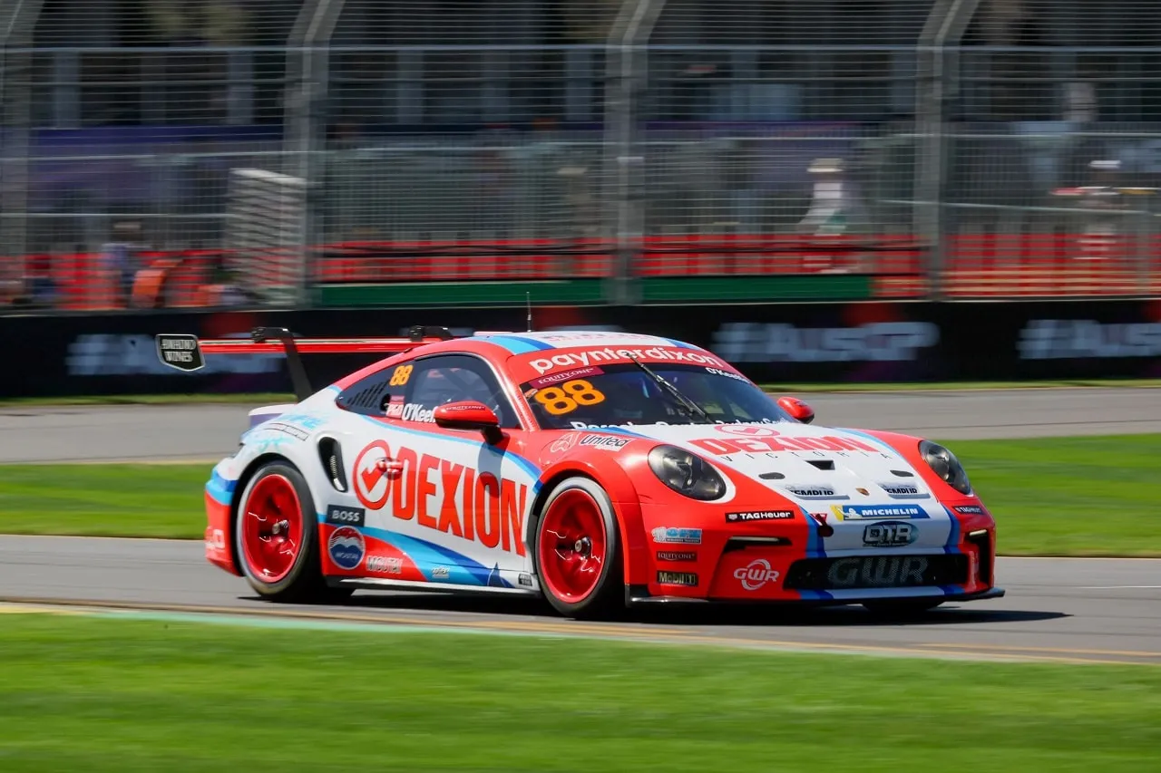 Number 88 Dexion Porsche 911 GT3 Cup car on a street circuit in front of a barrier fence