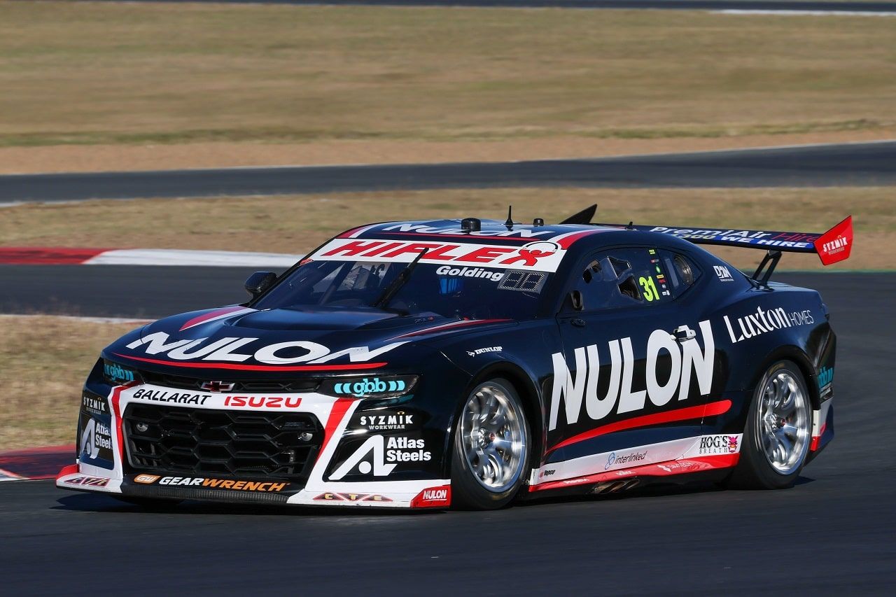 The black number 31 Nulon Racing Camaro driving on a circuit under a clear sky