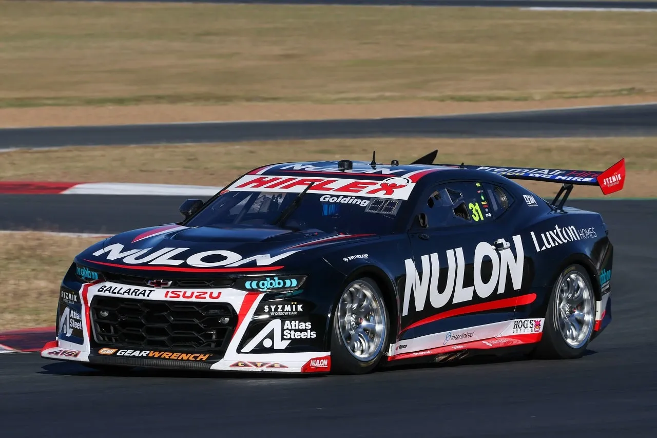 The black number 31 Nulon Racing Camaro driving on a circuit under a clear sky