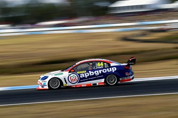 Side view of the #44 apbgroup Commodore Supercar blurred at speed on a circuit