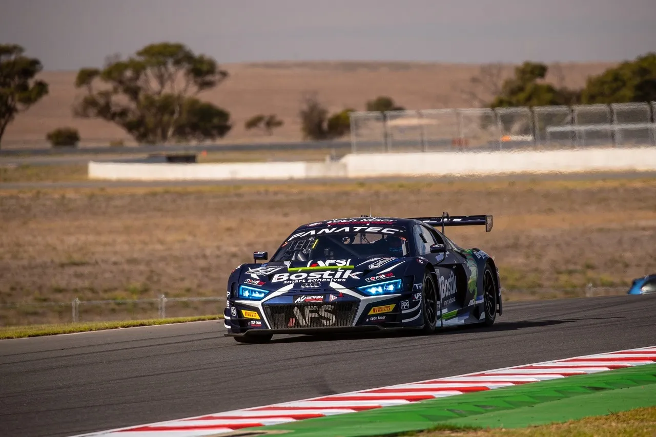 The dark blue Bostik Audi R8 GT3 car with AFS branding coming towards the camera on a dry track