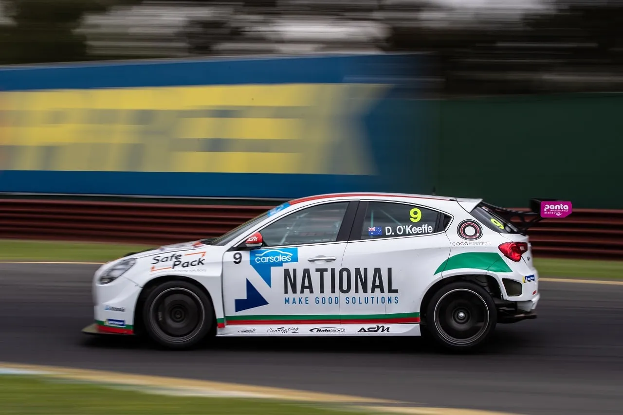 Dylan O’Keeffe’s white #9 Alfa Romeo Giulietta TCR car with National branding at speed, background blurred