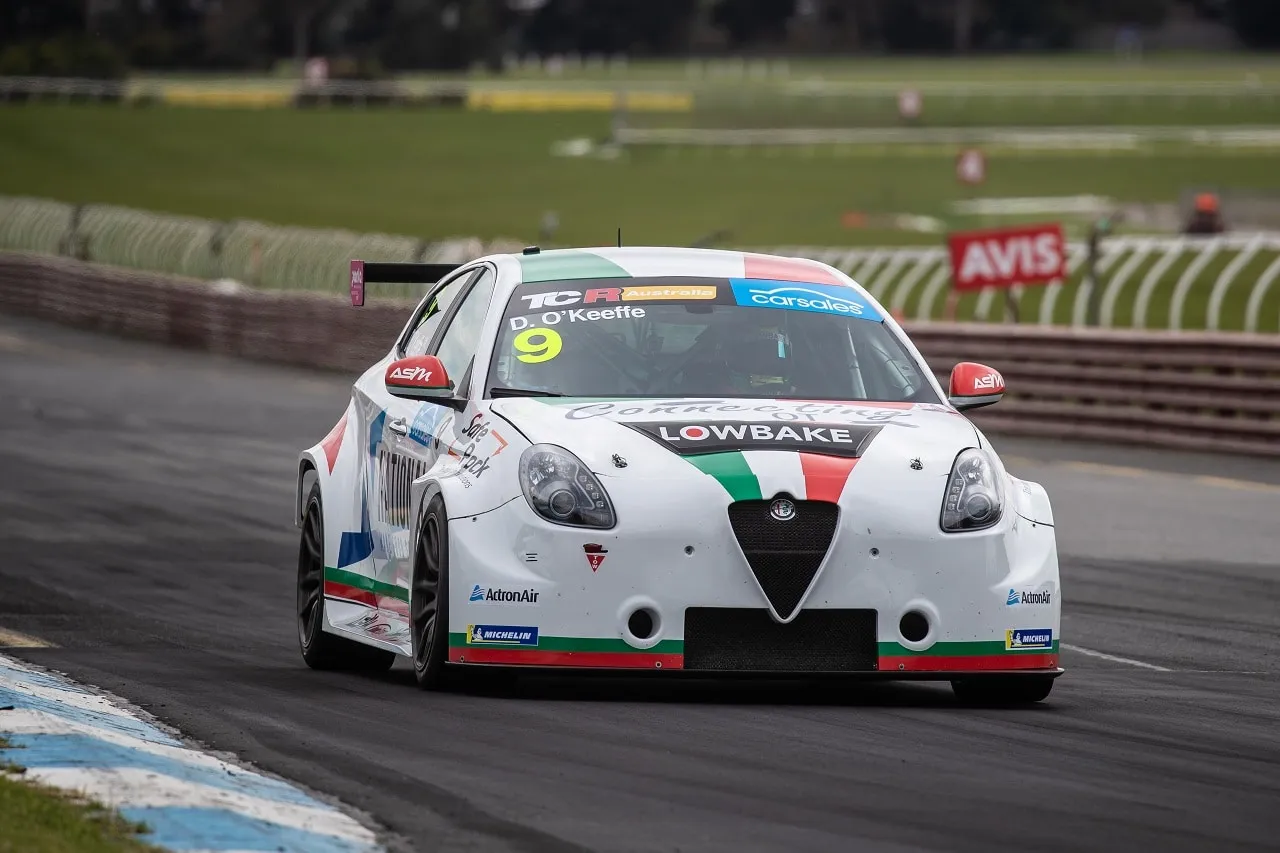 Dylan O’Keeffe’s white #9 Lowbake Alfa Romeo Giulietta TCR car cornering on a damp track