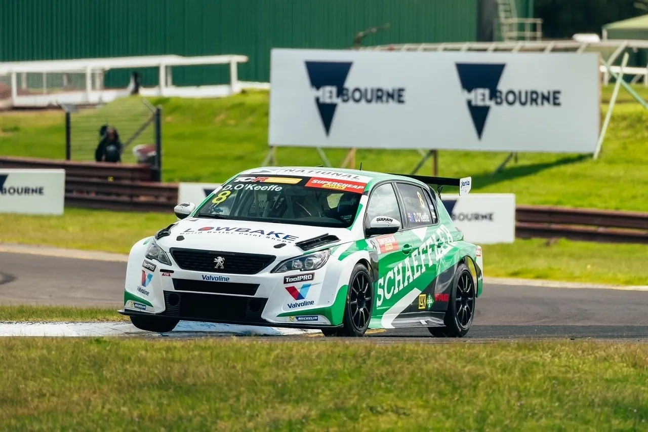 Dylan O’Keeffe’s #8 Schaeffler Peugeot 308 TCR car on track past Melbourne signage