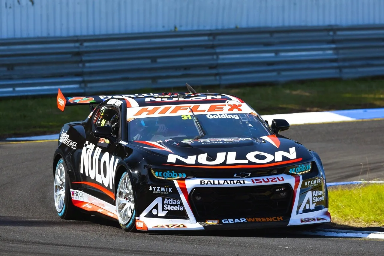 Front view of the black number 31 Nulon Racing Camaro on track at Sandown