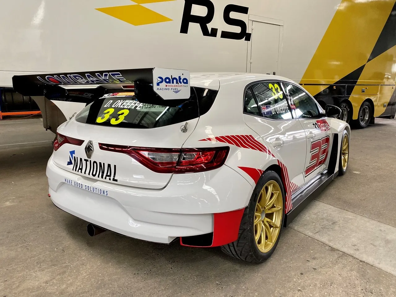Rear three-quarter view of the white #33 Renault Megane RS TCR car with Lowbake wing and National branding