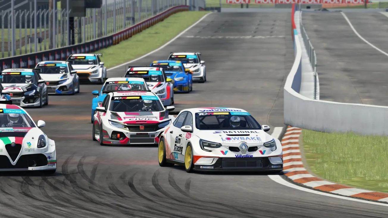 Sim racing screenshot of a pack of TCR cars at speed, led by the white Renault, on a circuit with orange and white kerbs