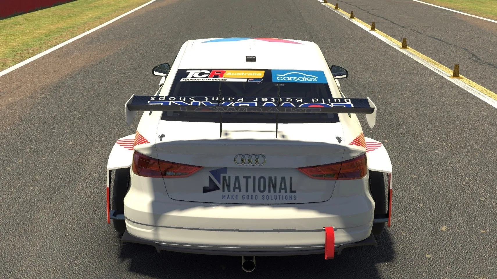 Sim racing screenshot of the rear of the white Audi RS3 TCR car on track, showing the National logo and Lowbake rear wing