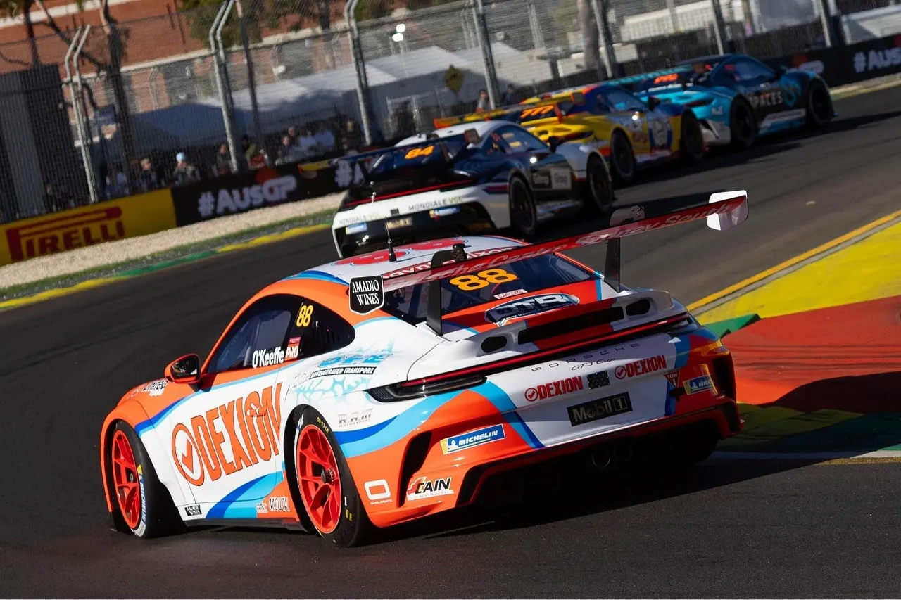 Rear three-quarter view of the number 88 Dexion Porsche Carrera Cup car racing on a street circuit