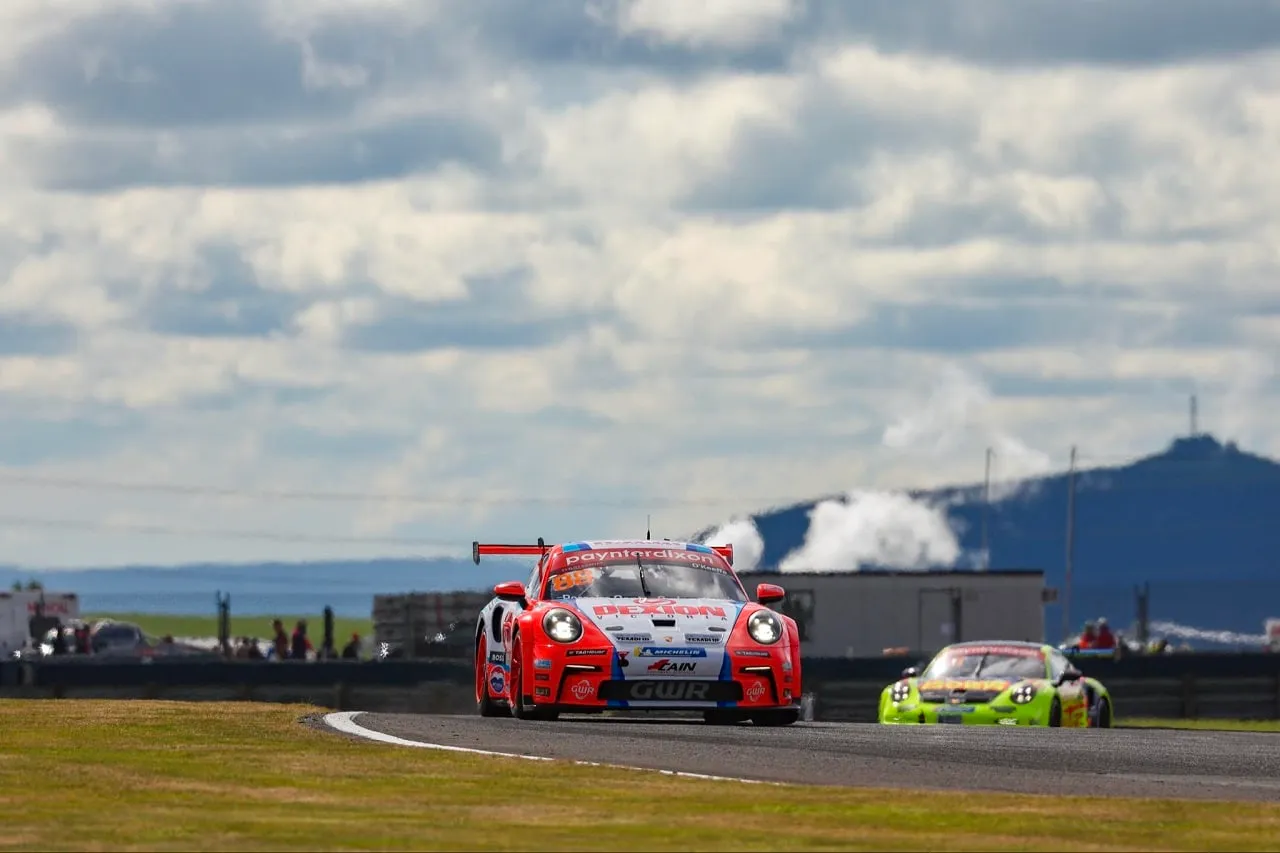 Number 88 Dexion Porsche Carrera Cup car heading towards the camera on track under a cloudy sky